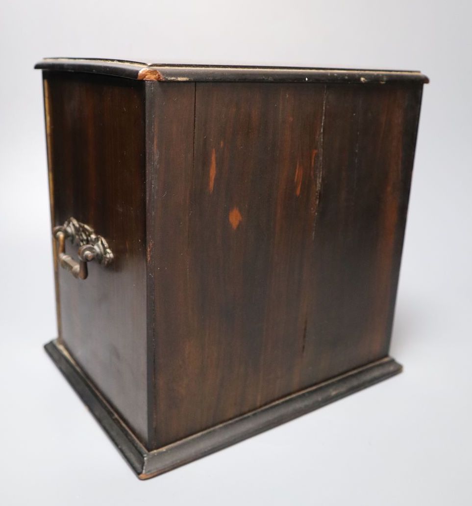A Victorian coromandel cabinet with three drawers and two doors, with key, 22cm wide